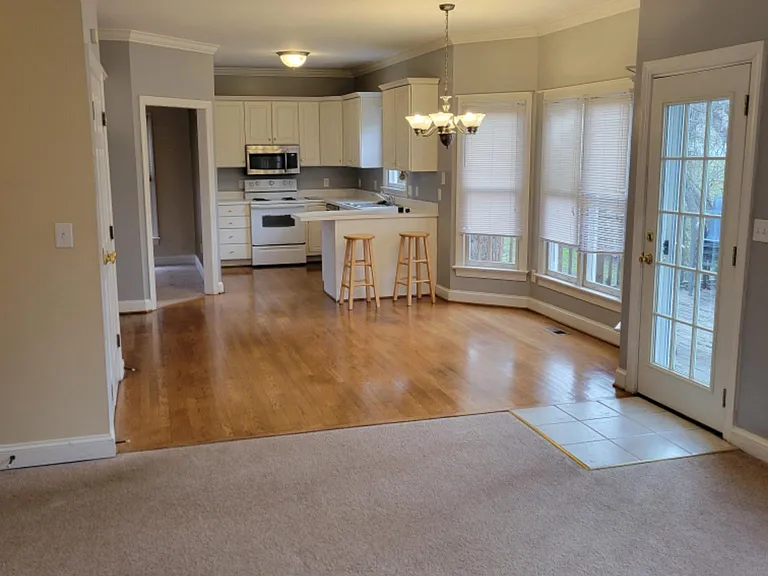 Looking from Den into open kitchen, with bar area.