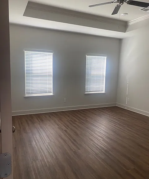Master Bedroom with windows, ceiling fan, hardwood floors
