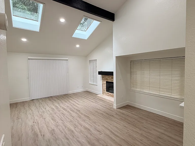 Large vaulted ceilings in the living room / dining room with slider access to the deck - the deck has a storage room on the right side