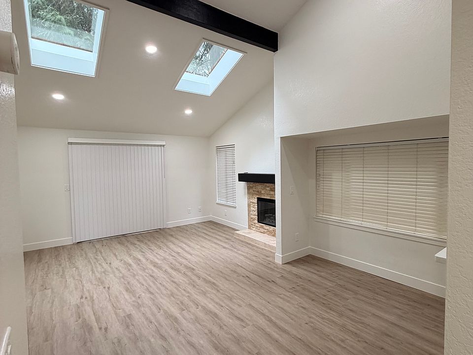 Large vaulted ceilings in the living room / dining room with slider access to the deck - the deck has a storage room on the right side