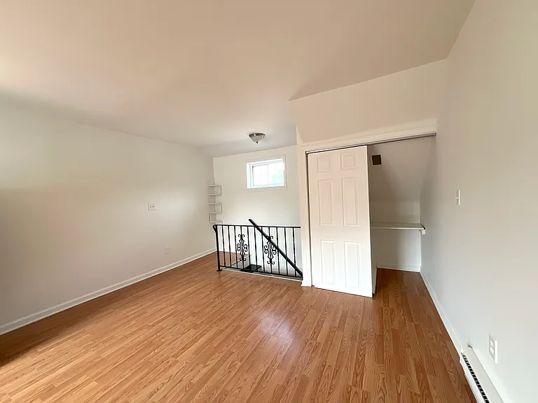 Spacious living room with closet and large windows