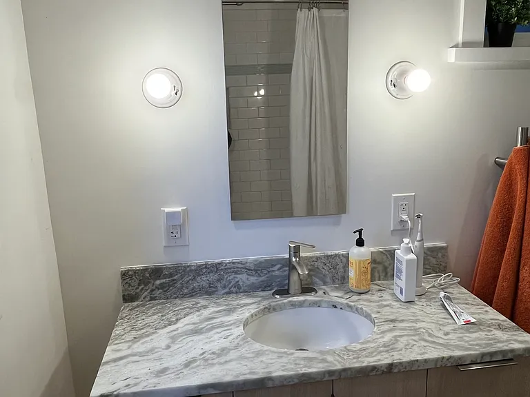 Wall mounted oak vanity, w/ wall recessed mirror cabinet.