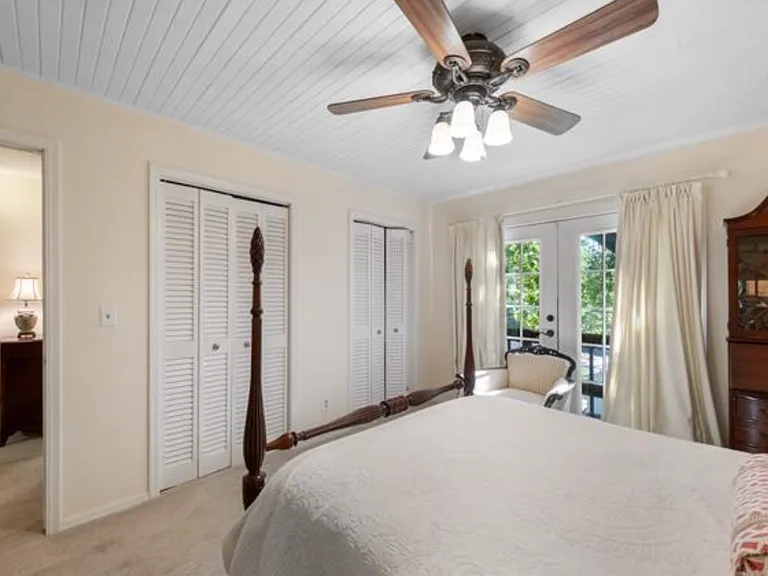 Top floor bedroom with French doors to private balcony.