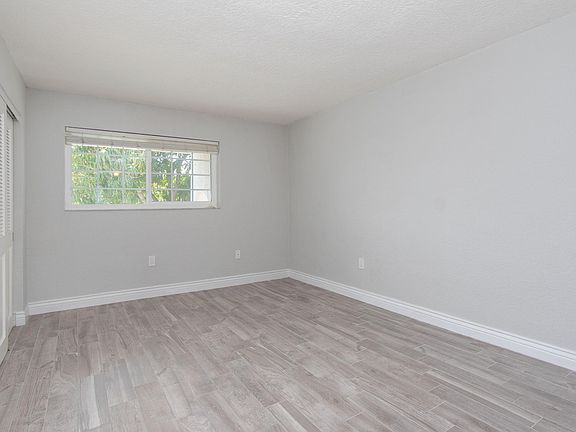 Bedroom 1: Beautiful floors and impact windows.