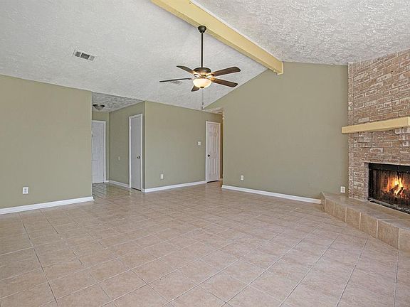 A corner gas log fireplace is sure to warm the hearts of all that gather here!