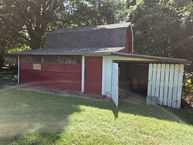 There is large covered storage on the back of the barn where you can park movers and larger equipment