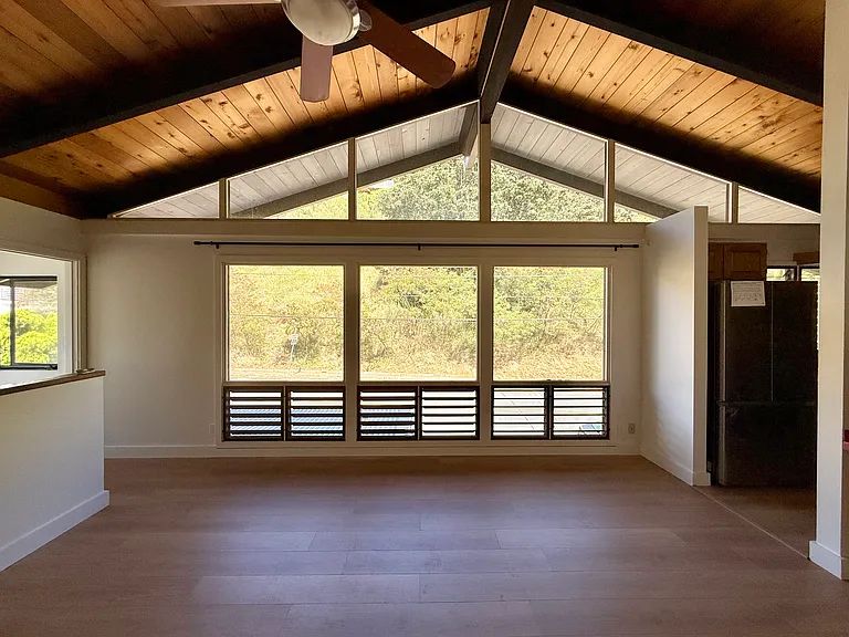 Enjoy peaceful mountain views through the large living room windows.