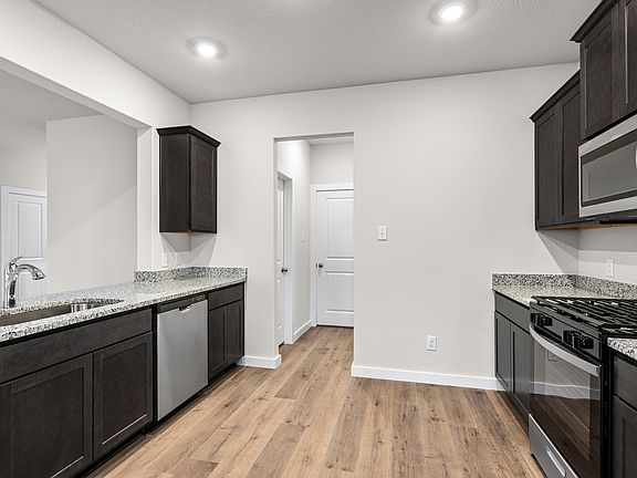 The kitchen has sprawling granite countertops.