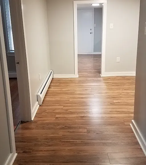 hallway to bedroom, kitchen and dining