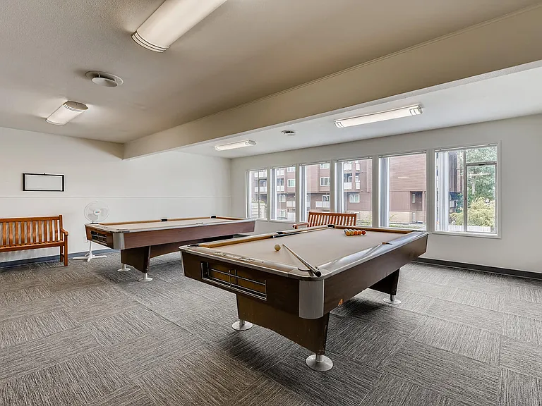 The Community Clubhouse with a Pool Table at Morningtree Park Apartments