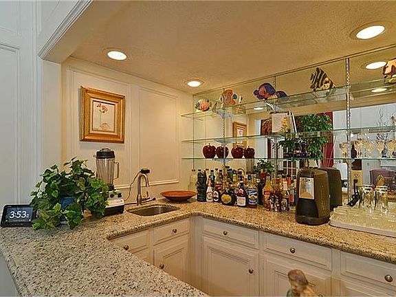 Hire a bartender or serve everyone yourself in this wonderful wet bar, updated with granite counters.