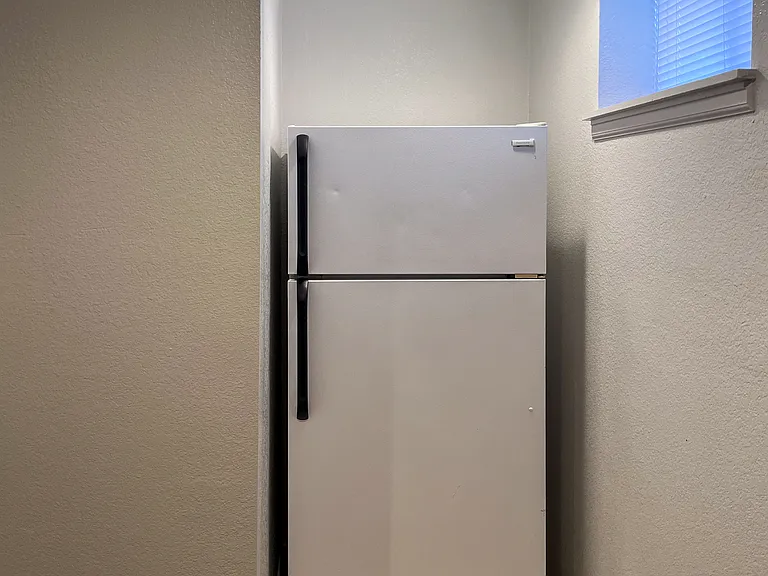 Den with fridge next to bedrooms C and D.