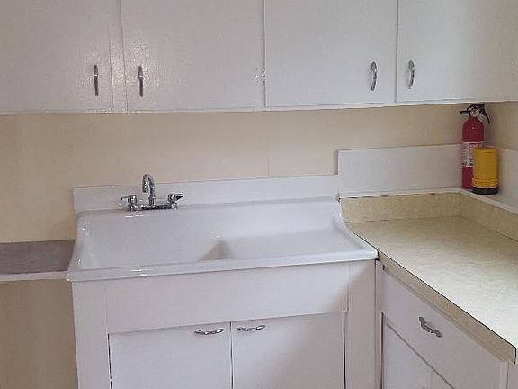 Kitchen with lots of cabinets. Stove and refrigerator