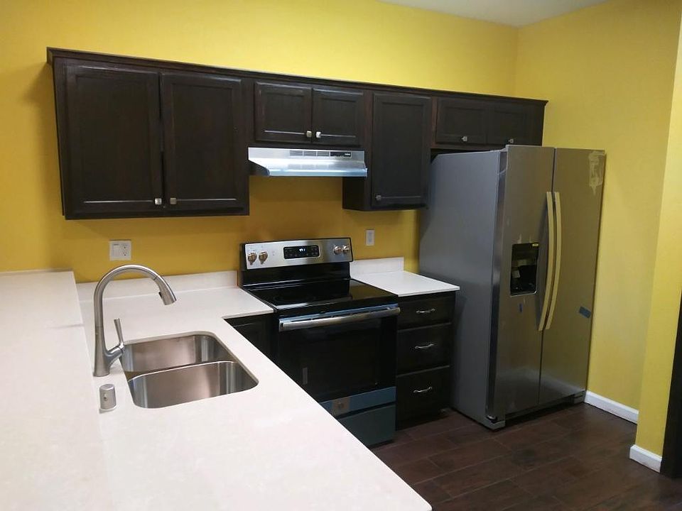Kitchen area with washer dryer on opposite side of photo and dishwasher under cabinet left of sink area