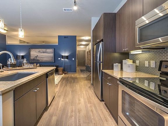 Gourmet kitchens with tile backsplash, granite counters and stainless appliances