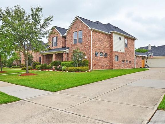 View of the large home with Long Driveway