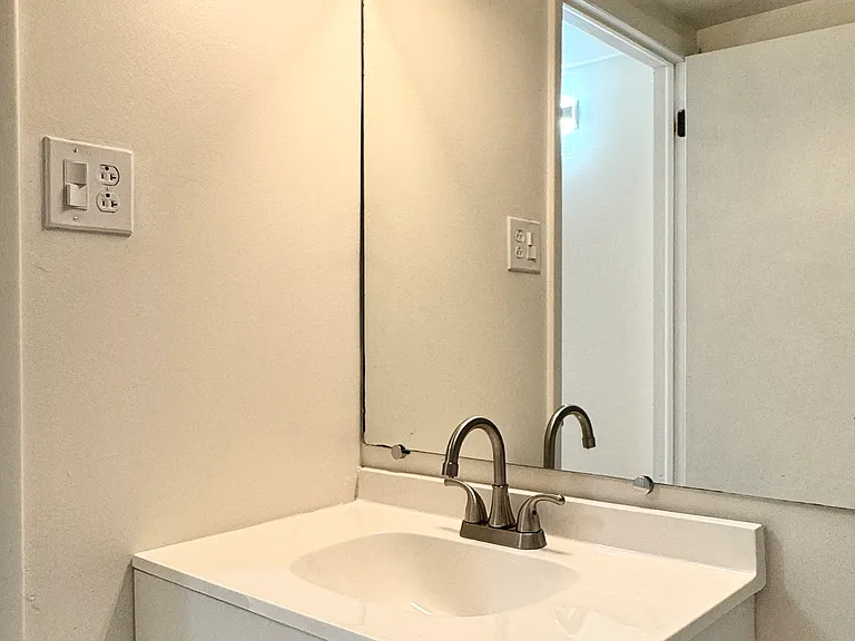 Updated hall bath with new vanity, new toilet, and new light fixture