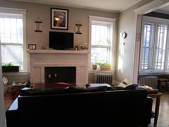 grand faux fireplace accommodates electric logs for a cozy yet elegant feel