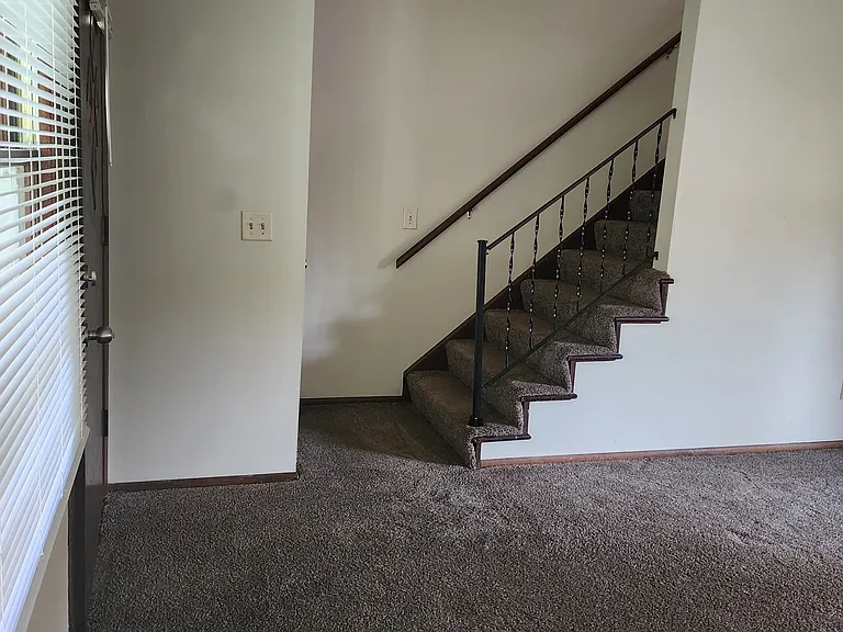 Stairs to bathroom and 2 bedrooms from living room.