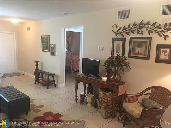 Spacious great room looking back to front door and private h