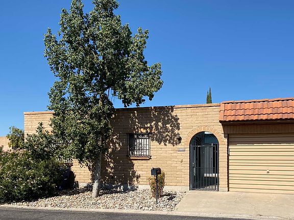 Outside showing gated front door and garage.