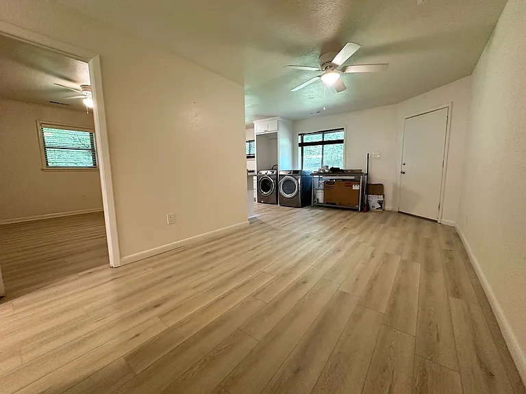 View from Living room towards front door and Dining area. Bedroom 1 is on the left. New LVP flooring.
