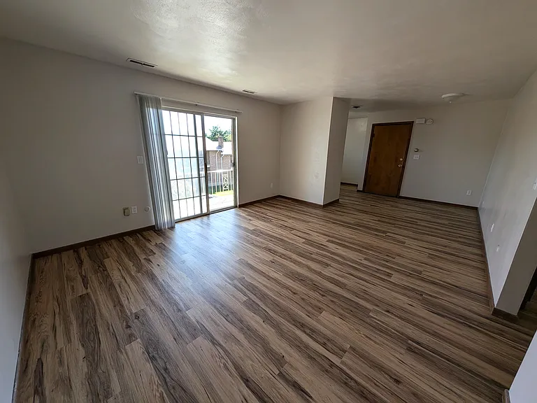 Expansive living room with a private balcony.