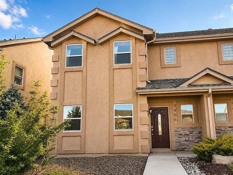 Your front door _ stone accents, covered entry, and plenty of Colorado sunshine
