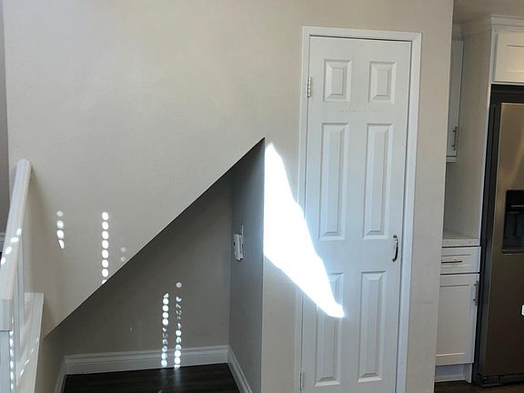 small cubby/nook under the stairs that is great for extra storage