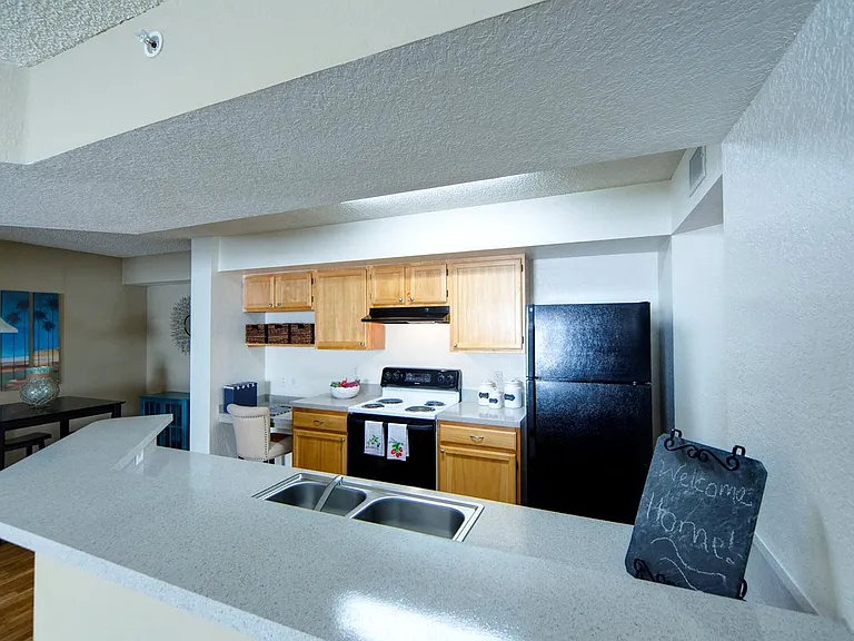 Kitchen with built-in desk area at Gregory Cove in Jacksonville, FL