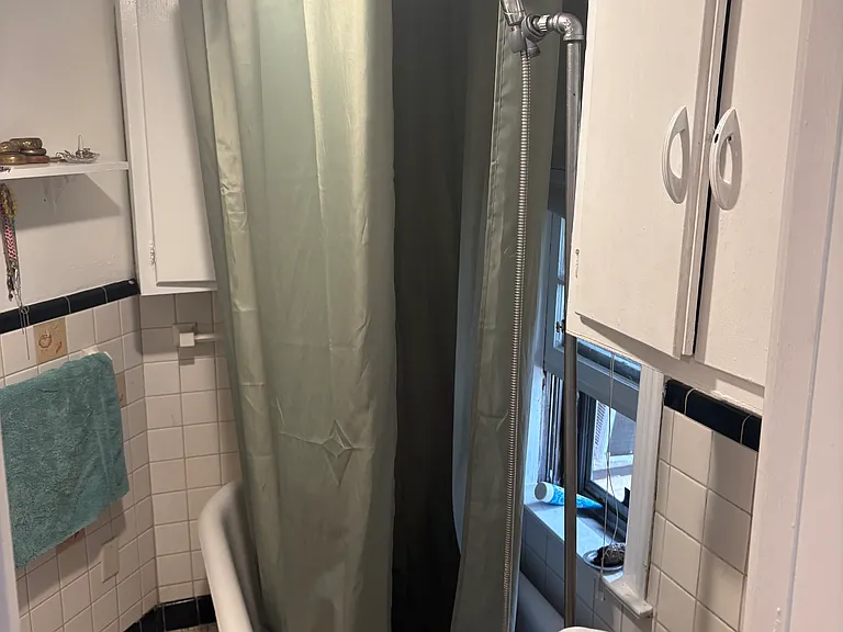 Bathroom with shower/tub and wall cabinet