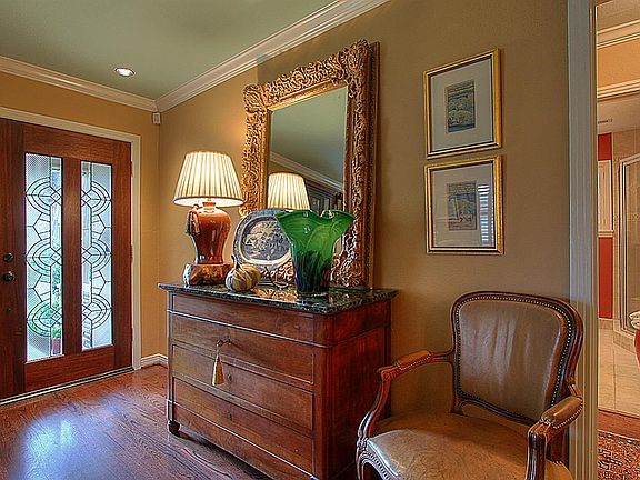 Leaded glass front door. and beautiful original wood floors.  Can lights and crown moulding.
