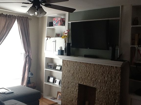 Living room with decorative fireplace and built-ins