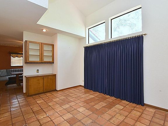 The formal dining room is adjacent to the breakfast area and kitchen, and looks out directly into the front private patio area.