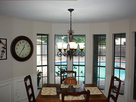 Upgraded lighting & stunning curved wall of windows. Notice the detailed chair railing.