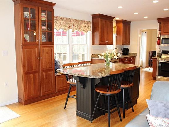 Built-in pantry and window seat next to the custom island with seating.