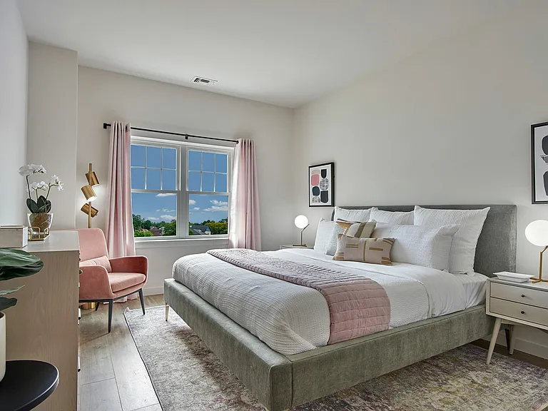 Step into elegance with this serene bedroom offering a tranquil ambiance and a picturesque view.