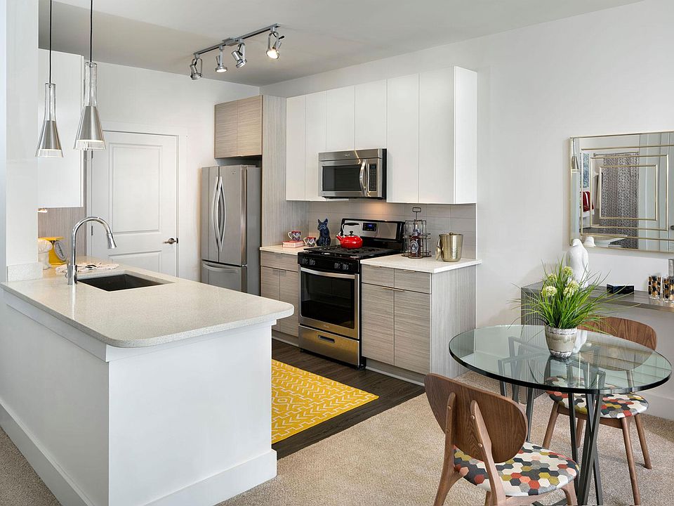 The gourmet kitchen features a gas range, recycled glass countertops and stainless steel appliances.