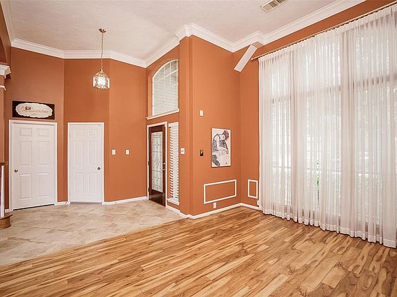 Entry into formal living and dining rooms with tall ceilings and floor to ceiling window for great natural light.Door to garage in the center, door to laundry on the left