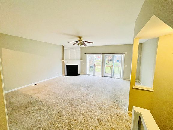 Spacious living space with gas fireplace and in-wall speaker system.