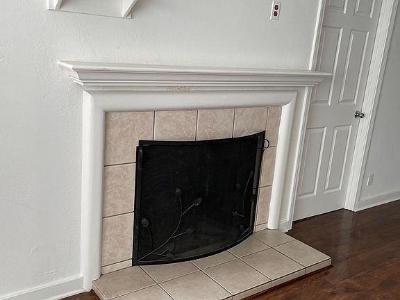 Operational wood burning fire place in living room.