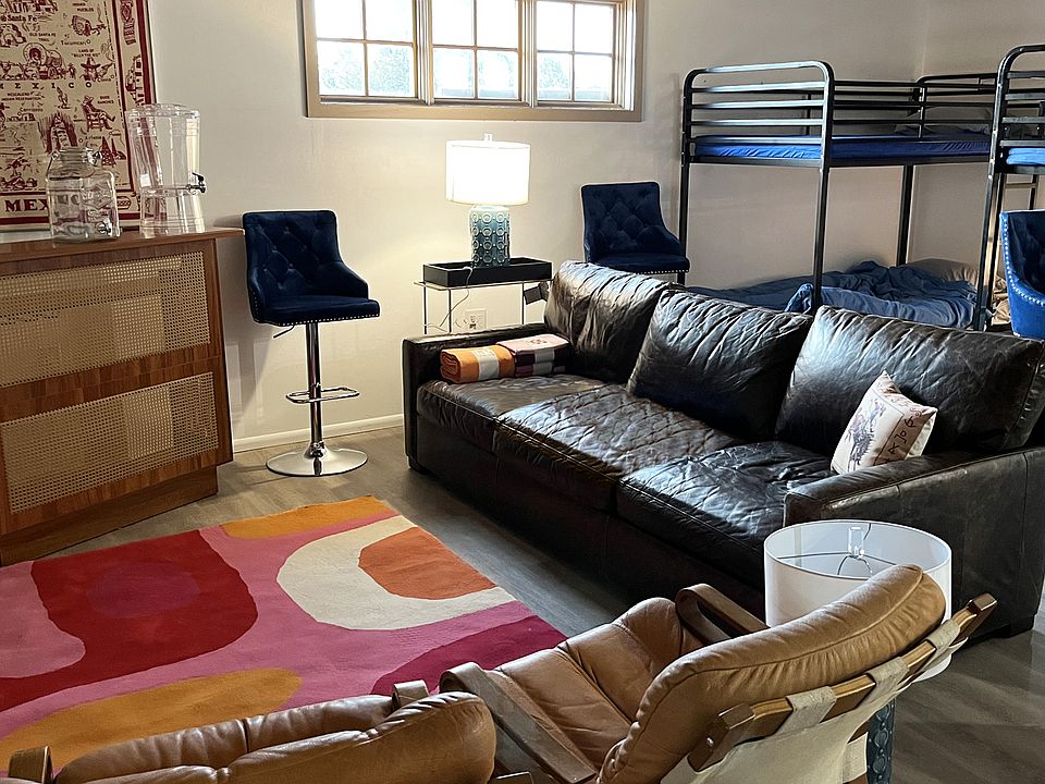 Living room and bar area with bunk beds in background