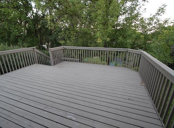 Large deck off the informal dining area that walks down to the backyard.