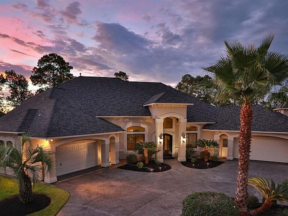 FOUR CAR GARAGE - Built by custom home builder, Frontier Homes, this one-of-a-kind home is grand but intimate and offers the finest in craftsmanship. The stamped concrete circular driveway leads to two - two car garages, all beautifully showcased wit