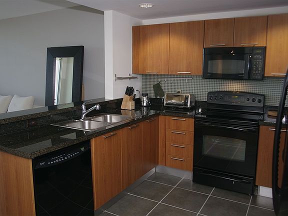 Kitchen: granite counters and glass tile backsplash.