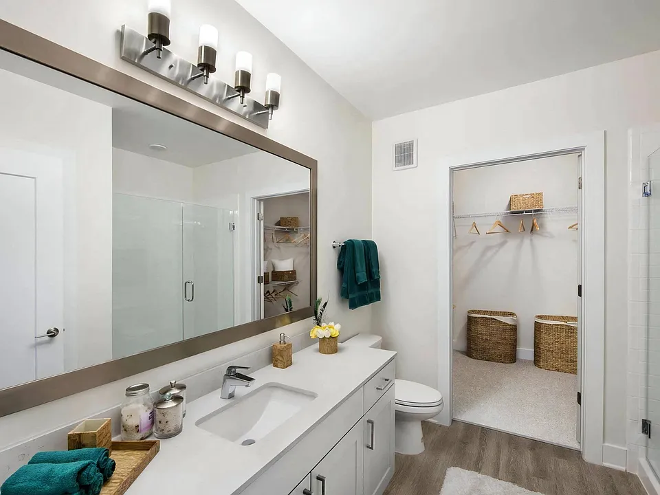 A closet opens directly off the bathroom, fitted out with wire shelving.