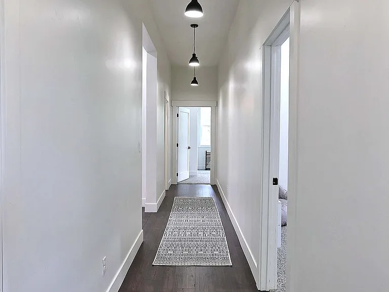 Hallway - Leads to Secondary Suite #2, Half Bath, Two Bedrooms, Laundry Room