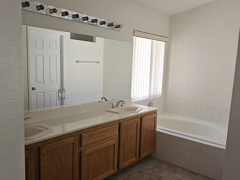 Double vanity with ample storage offers functional elegance in this primary bathroom.