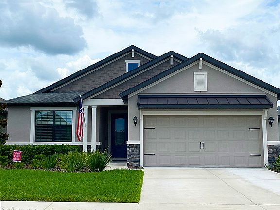 Sanibel home Coastal elevation with stone new home front exterior William Ryan Homes Tampa