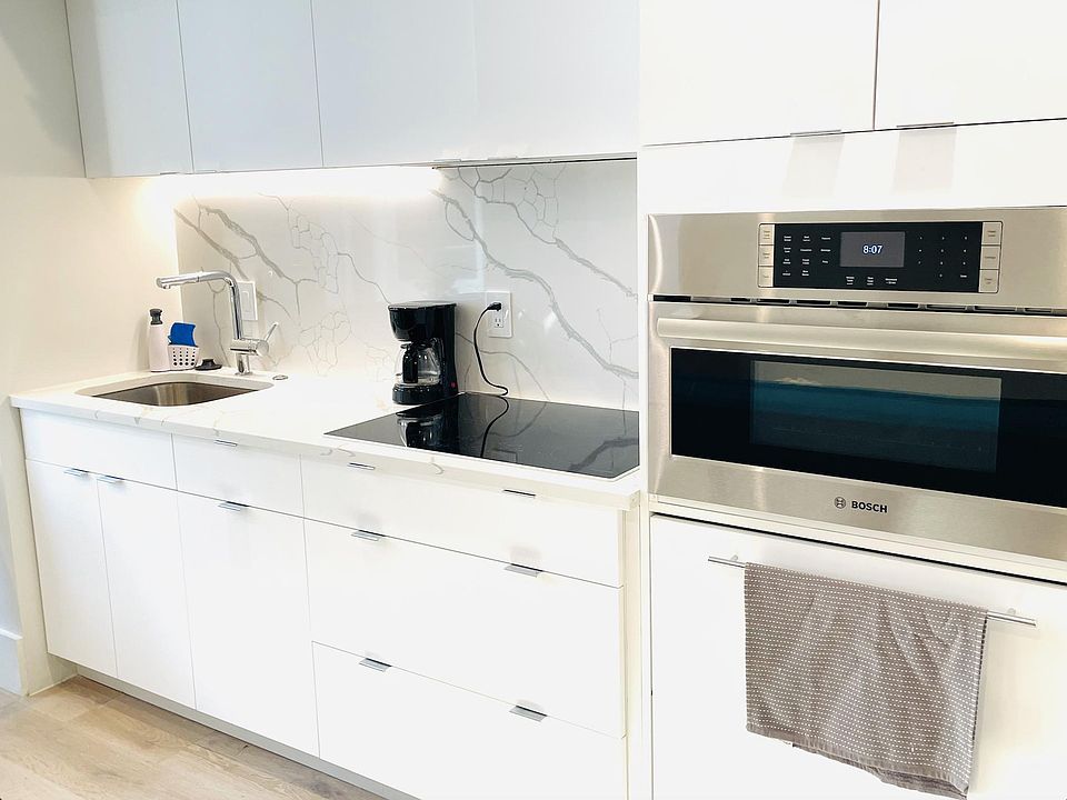 Induction cooktop, Bosch microwave/oven combo, full size dishwasher & refrigerator.